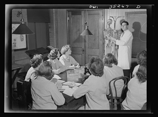 "Black-and-white photograph of student nurses gathered around a cadaver, observing an anatomy lesson at Johns Hopkins Hospital, Baltimore, Maryland, 1943." (Photograph by A. Rosner, courtesy of the Library of Congress, https://www.loc.gov/resource/fsa.8d31908/)