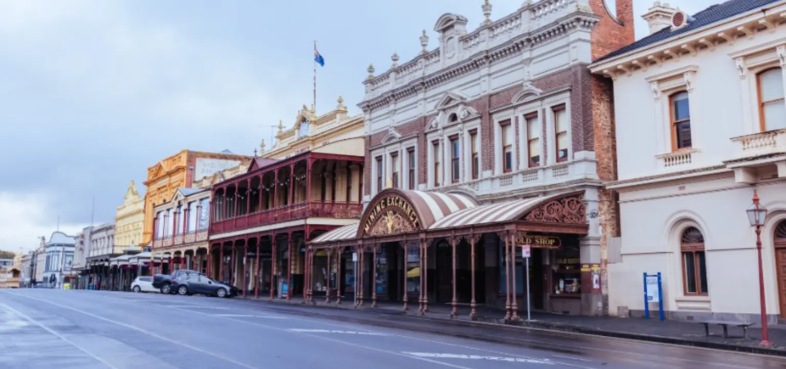 A line of historic buildings on a wet street