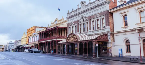 A line of historic buildings on a wet street