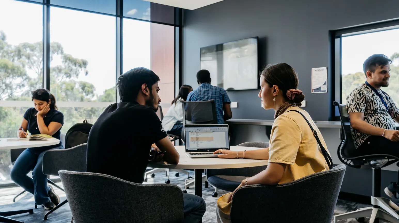 Two people talking in a classroom