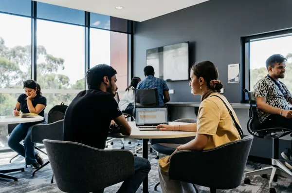 Two people talking in a classroom