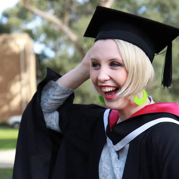 Photo of a smiling young female on graduation day.
