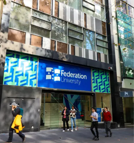Outside photo of Federation University Melbourne City Campus with people passing on the street.