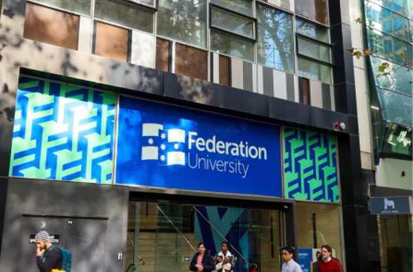 Outside photo of Federation University Melbourne City Campus with people passing on the street.