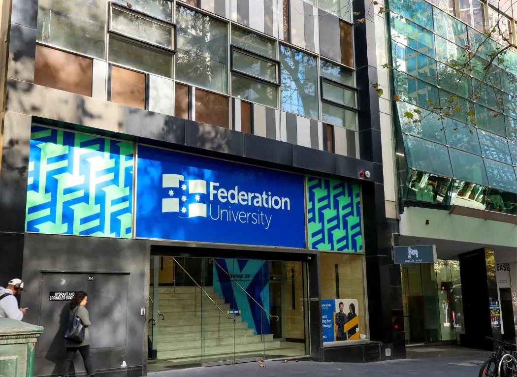 Outside photo of Federation University Melbourne City Campus with people passing on the street.