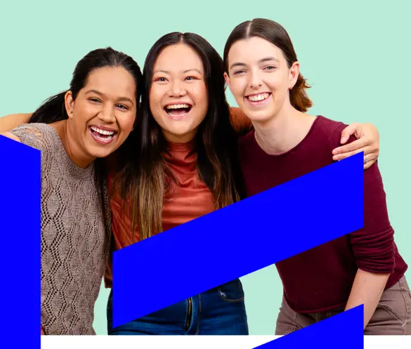 Photo of three women standing close and smiling.