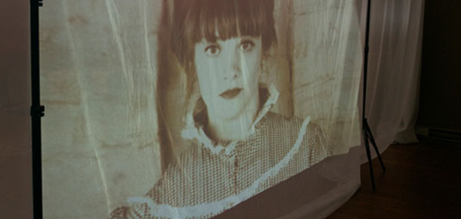 Image of a woman projected onto fabric