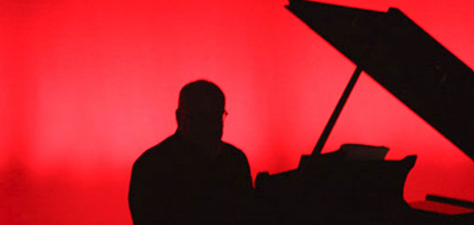Silhouette of person playing piano